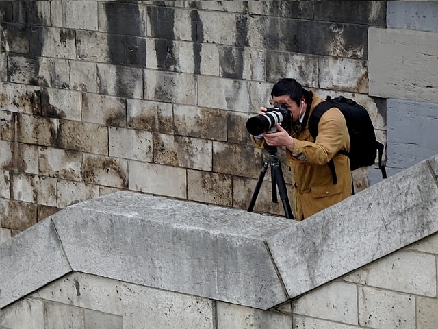 Photographer in Paris, France with a zoom lens