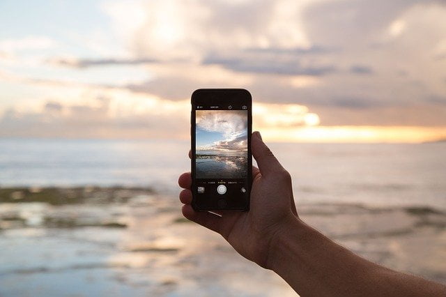 Phone taking photo of beach