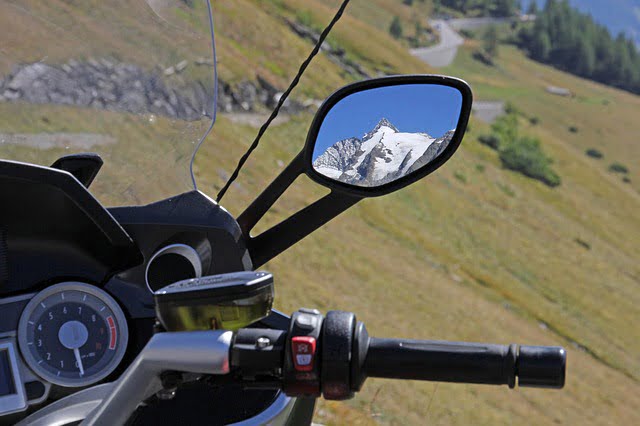 Motorcycle mountains views in rearview mirror 