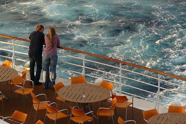 Cruise ship couple looking over deck